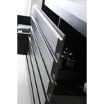 Close-up of partially opened white drawers with integrated handles on the Matera 60 Inch Wall Mount Double Bathroom Vanity With Countertop reveals personal care items inside, showcasing its sleek, minimalist design.