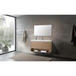 A modern bathroom features the Matera 48 Inch Wall Mount Bathroom Vanity With Countertop, a rectangular mirror, wall-mounted sink, two beige towels on hooks, a potted plant, and a large window that lets in natural light.