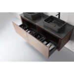 The Ocala 60 Inch Wall Mount Bathroom Vanity With Vessel Sink includes a dark countertop, two black vessel sinks, and an open wooden drawer with compartments for organizing toiletries and personal care items.