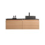 The Ocala 60 Inch Wall Mount Bathroom Vanity With Vessel Sink has a ribbed light wood finish, sleek black countertop, rectangular vessel basin with black faucet, and space beside the sink for two bottles.