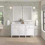 A modern bathroom showcases the Lorelai 60 inch Double Bathroom Vanity, complemented by two spacious mirrors, wall sconces, white towels on rings, a vase of flowers on the counter, light wood floors, and sunlight streaming through a window.