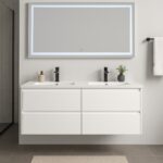 A modern bathroom with a floating white double vanity, two black faucets, a small potted plant, a large backlit mirror, and a towel hanging on a black rod on a light-colored wall.