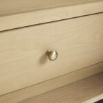 Close-up of a closed light wood drawer with a round gold knob on the Solene 36 inch Bathroom Vanity Cabinet, highlighting its visible wood grain and texture.