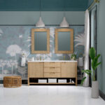A stylish bathroom with a Solene 72 inch Double Bathroom Vanity Cabinet featuring rattan fronts, two rectangular mirrors, pendant lights, tropical wallpaper, plants, a wicker stool, and rolled towels on the vanity’s lower shelf.