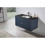 The Barcelona 42 Inch Wall Mount Bathroom Vanity features a ribbed dark blue cabinet, black countertop with integrated sink, and matte black faucet and accessories. A large window offers a view of greenery in the background.