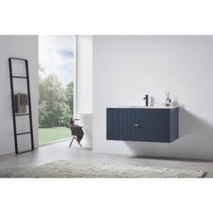 A modern bathroom with a large window, a blue Barcelona 42 Inch Wall Mount Bathroom Vanity with a black faucet, a ladder towel rack, a chair, and a light rug on concrete flooring. Trees can be seen outside.