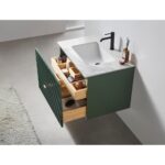 The Barcelona 30 Inch Wall Mount Bathroom Vanity has a white marble countertop, black faucet, green cabinet, open wood drawers with organized toiletries, and a cream rug partly on the floor.