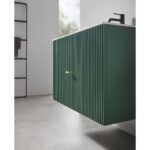 A modern bathroom features the Barcelona 30 Inch Wall Mount Bathroom Vanity in green with vertical grooves, a white countertop, and a black faucet. The minimalist space includes a window and a black towel rack in the background.