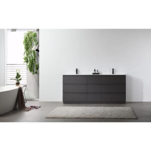 Minimalist bathroom featuring a Rothenburg 72 Inch Freestanding Bathroom Vanity, small bottles on the counter, a freestanding tub, beige rug, and a wall of green plants by a bright window.