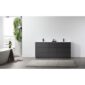 Minimalist bathroom featuring a Rothenburg 72 Inch Freestanding Bathroom Vanity, small bottles on the counter, a freestanding tub, beige rug, and a wall of green plants by a bright window.