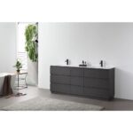 Modern bathroom with a Rothenburg 72 Inch Freestanding Bathroom Vanity in dark wood, a gray rug, white bathtub with brown towel, small table with plant, and natural light pouring through a side window framed by leafy greenery.