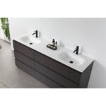 The Rothenburg 72 Inch Freestanding Vanity features a double sink with matte black faucets, a dark wood finish, and a white countertop. A small tray with soap and bottles sits between the sinks; lush greenery accents the background.