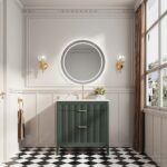 Elegant bathroom with black-and-white checkered floor, Aveline 36 Inch Freestanding Bathroom Vanity with Top and gold handles, round backlit mirror, gold wall sconces, brown curtains, window for natural light, and flowers on the vanity.