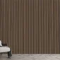 A modern interior showcases a 3D Interior Wall Panel with brown and black stripes, a white and gray armchair draped with a blanket, a gold floor lamp, and sheer gray curtains on the window letting in natural light.