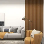 A modern living room with a light gray sofa, mustard throw blanket, assorted pillows, a round mustard armchair, floor lamp, abstract wall art, and a 3D Interior Wall Panel as a stylish wood slat accent wall.