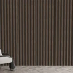 A modern minimalist room features a gray armchair, black floor lamp, and the 3D Interior Wall Panel with black-and-brown vertical stripes. Sunlight streams through sheer white curtains on tall windows; a pillow and blanket rest on the chair.