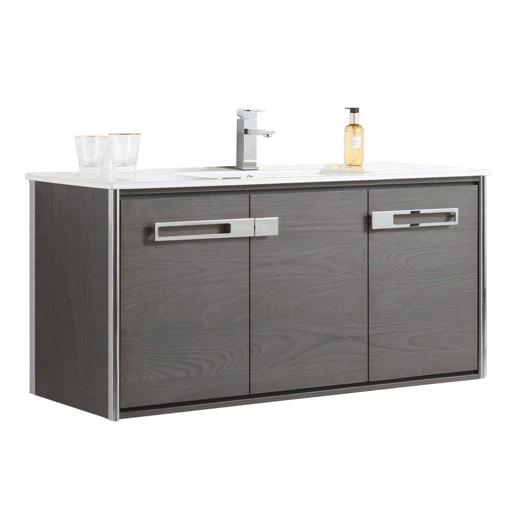 The Oakville 48 inch Modern Bathroom Vanity is wall-mounted with a dark wood finish, rectangular sink, chrome faucet, two glasses, soap dispenser on top, and three doors featuring sleek horizontal handles.
