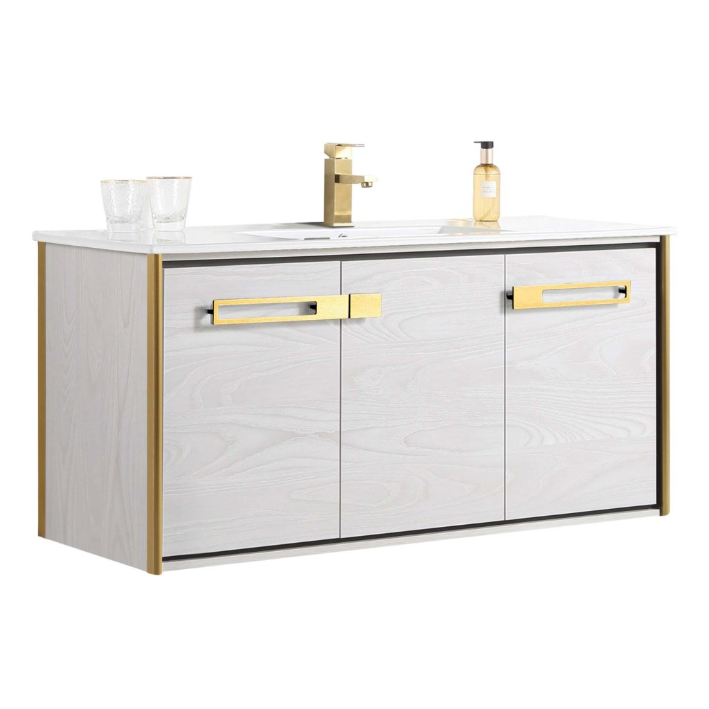 The Oakville 48 inch Modern Bathroom Vanity in white includes gold handles and trim, a built-in sink, gold faucet, and is accessorized with two clear glasses and a soap dispenser on the countertop.