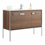 The Oakville 48 inch Modern Bathroom Vanity features a wood finish, metal legs, two spacious drawers, and a white countertop with faucet, two clear glasses, and a soap dispenser.