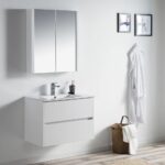 Minimalist bathroom featuring a white Valencia 30 inch Wall Mount Vanity With Sink, mirrored cabinet, faucet and toothbrush holder on the sink, two framed pictures, a robe on a hook, and a wicker basket with a towel on the floor.