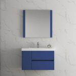 The bathroom showcases the Valencia 36 inch Wall Mount Vanity With Sink, a stylish blue floating vanity with a rectangular basin, sleek faucet, and a large mirror with blue accents set against light gray marble-patterned walls.