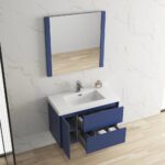 The Valencia 36 inch Wall Mount Vanity With Sink includes a white basin, blue drawers with toiletries, and a large rectangular mirror above, all set against a marble-patterned wall and light wood flooring.