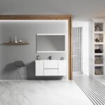 Modern bathroom with a floating Valencia 48 inch Wall Mount Vanity With Sink, large mirror, gray accent wall, wooden decor shelf, gray stool, marble floors and walls, open shelving, and black-tiled shower.