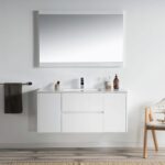 A minimalist bathroom with a Valencia 48 inch Wall Mount Vanity With Sink, topped by a large mirror, black towel rail, toiletries on the counter, wooden chair with towel, and a striped rug over wood flooring.