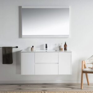 A minimalist bathroom with a Valencia 48 inch Wall Mount Vanity With Sink, topped by a large mirror, black towel rail, toiletries on the counter, wooden chair with towel, and a striped rug over wood flooring.