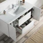 The Valencia 48 inch Wall Mount Vanity With Sink offers a modern white look with open cabinet doors and drawers for toiletries, sitting on a wood-look floor beside a beige textured rug—ideal for a stylish, functional bathroom update.