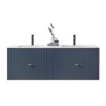 The Barcelona 60 Inch Wall Mount Double Bathroom Vanity With Top features a navy blue, vertically grooved front, gold handles, and two black faucets. The countertop is accented with decorative vases and a folded towel.
