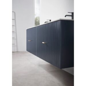 Modern bathroom with a Barcelona 60 Inch Wall Mount Double Bathroom Vanity With Top in navy blue, enhanced by vertical grooves, brass handles, and black faucets. Light gray floor and large window complete the bright, minimalist style.