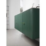 A modern kitchen with green, wall-mounted cabinets featuring vertical grooves and gold handles, inspired by the sleek style of the Barcelona 60 Inch Wall Mount Double Bathroom Vanity With Top, set against a light floor and minimal decor.