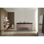 Modern bathroom featuring the Bibury 60 Inch Double Bathroom Vanity with Top, black countertop, and gold faucets. Open shelves with decor, a standing mirror, beige rug, and a window with sheer curtains invite soft natural light.