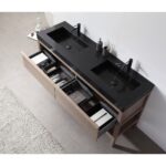 The Bibury 72 Inch Double Bathroom Vanity with Top features a modern black double sink, matte black faucets, and open wooden drawers organized with toiletries, towels, and boxes. A stylish tiled floor showcases a partially visible rug.