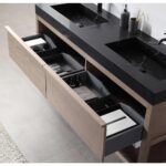 Open wooden vanity drawers beneath a black double sink countertop, organized with trays for bottles, towels, and containers—showcasing the Bibury 72 Inch Double Bathroom Vanity with Top in a modern bathroom with light gray tiled flooring.