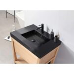A modern Bibury 36 Inch Bathroom Vanity with Top features a black rectangular sink, matte black faucet, soap dispenser, toothbrush holder, and light wood cabinet against a white wall and gray tiled floor.