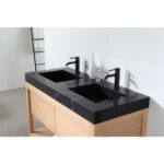The Bibury 48 Inch Double Bathroom Vanity with Top features a black marble countertop, two rectangular sinks with black faucets, and a light wood cabinet. A decorative glass vase sits elegantly between the sinks.