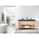 A modern bathroom features a freestanding white bathtub and the Bibury 60 Inch Double Bathroom Vanity with Top, which has double sinks, a black countertop, light wood cabinets, and tidy bottles. A ladder towel rack stands by a window with lush greenery.