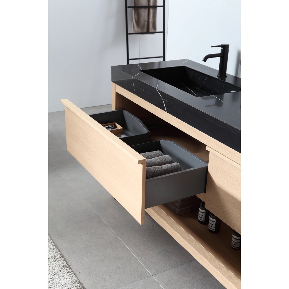 The Bibury 72 Inch Double Bathroom Vanity with Top features a black countertop, rectangular sinks, matte black faucets, and light wood drawers that open to reveal neatly folded towels and organized compartments.