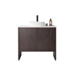 The Celle 36 Inch Bathroom Vanity With Vessel Sink showcases a dark wood cabinet, a white countertop with a round basin, a black faucet, and decorative accents such as a small round container and brown bottle on the right side.