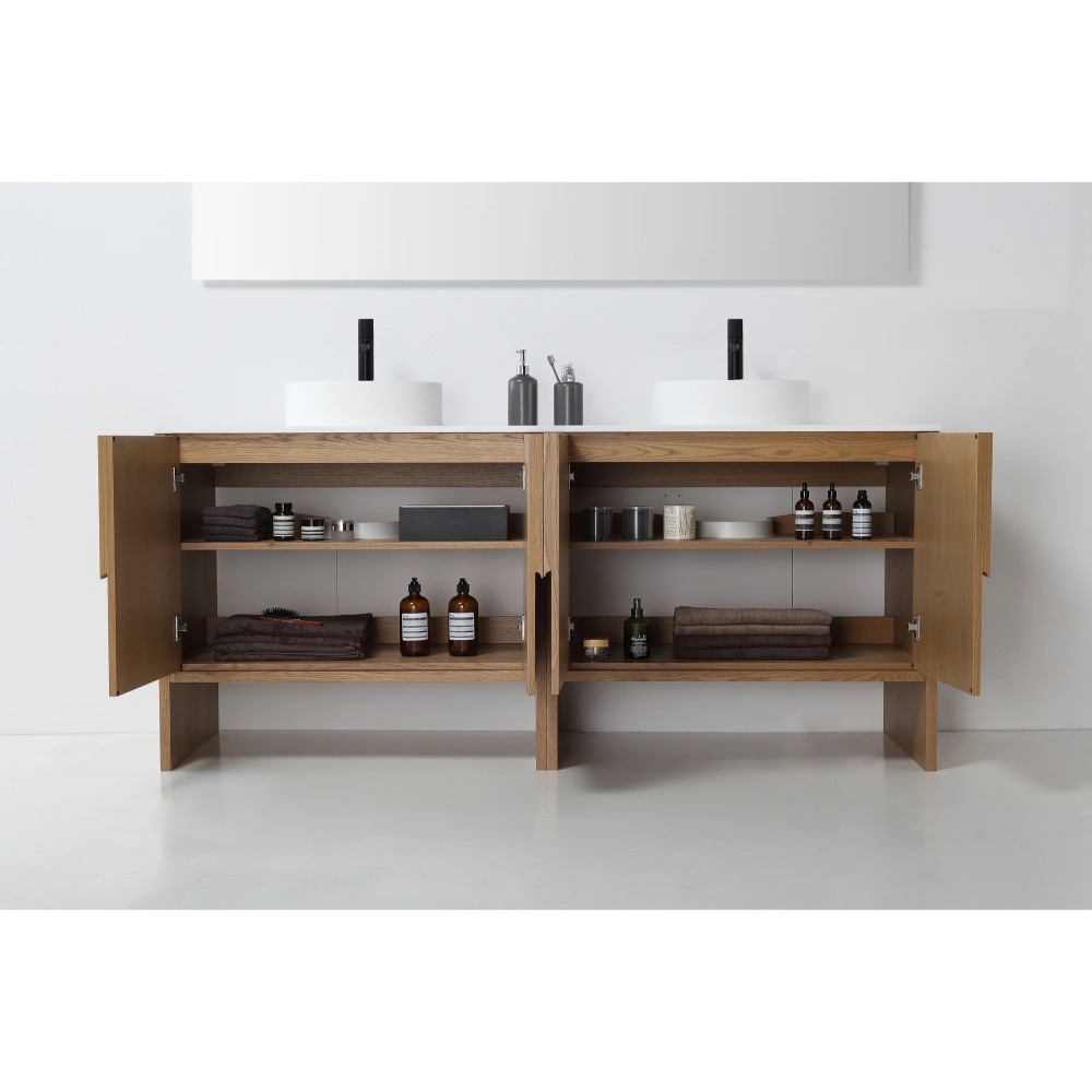 The Celle 72 Inch Double Bathroom Vanity With Vessel Sinks features open wooden cabinets for neatly folded towels, bottles, jars, and bath accessories, topped with two white vessel sinks and soap dispensers.