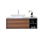 The Goreme 48 Inch Wall Mount Bathroom Vanity With Vessel Sink includes two wooden drawers, open shelves for towels and toiletries, a white vessel sink, and comes accented with a decorative white orchid in a pot.