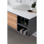 The Goreme 48 Inch Wall Mount Bathroom Vanity With Vessel Sink features an open shelf with two small green bottles, two rolled gray towels, a white countertop and sink, a plant, and a hairbrush.
