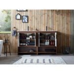 Two open bathroom cabinets, like the Lyon 60 Inch Double Bathroom Vanity with Top, are filled with toiletries and towels against a wooden plank wall, while minimalist decor and framed art hang above as light streams in over the striped rug below.
