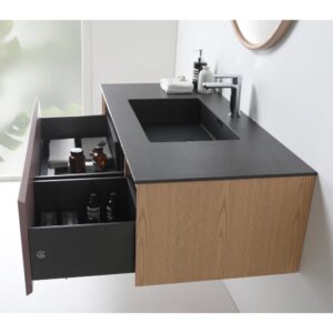 The Oslo 48 Inch Wall Mount Bathroom Vanity showcases a modern wood finish, black countertop, integrated sink, white faucet, and two open drawers for towels and toiletries—with natural light streaming in from the left.