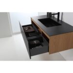 The Oslo 48 Inch Wall Mount Bathroom Vanity features two open drawers with dark towels and toiletries, a black sink and faucet, and a wood finish, all mounted against a white wall and floor.