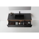 A modern black Oslo 60 Inch Wall Mount Single Bathroom Vanity with an integrated sink, two open drawers holding towels, containers, a toiletry bag, and bottles, viewed from above against a white wall and floor.
