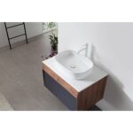 A modern bathroom features a Ronda 30 Inch Wall Mount Bathroom Vanity with a vessel sink, white faucet, gray floor tiles, a small potted plant, and a black towel rack against a white wall.