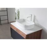 The Ronda 30 Inch Wall Mount Bathroom Vanity with vessel sink features a white rectangular basin, minimalist faucet, and wood-accented cabinet. A tall ladder shelf and greenery by the window complete this modern bathroom setup.